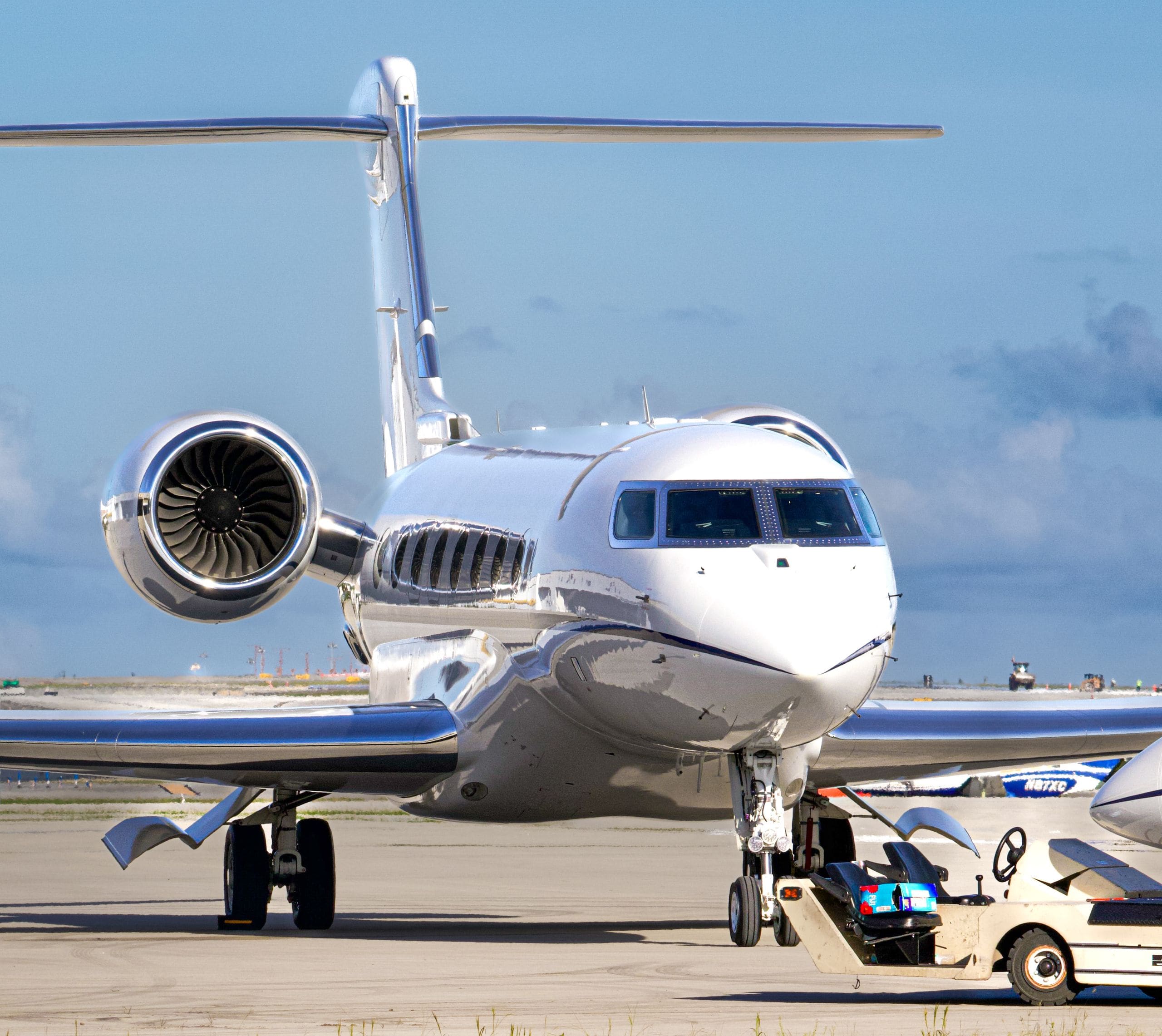 Flight crew crossing the tarmac toward a private jet at dawn